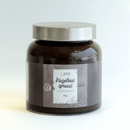 Jar of hazelnut spread with a silver lid on a white background