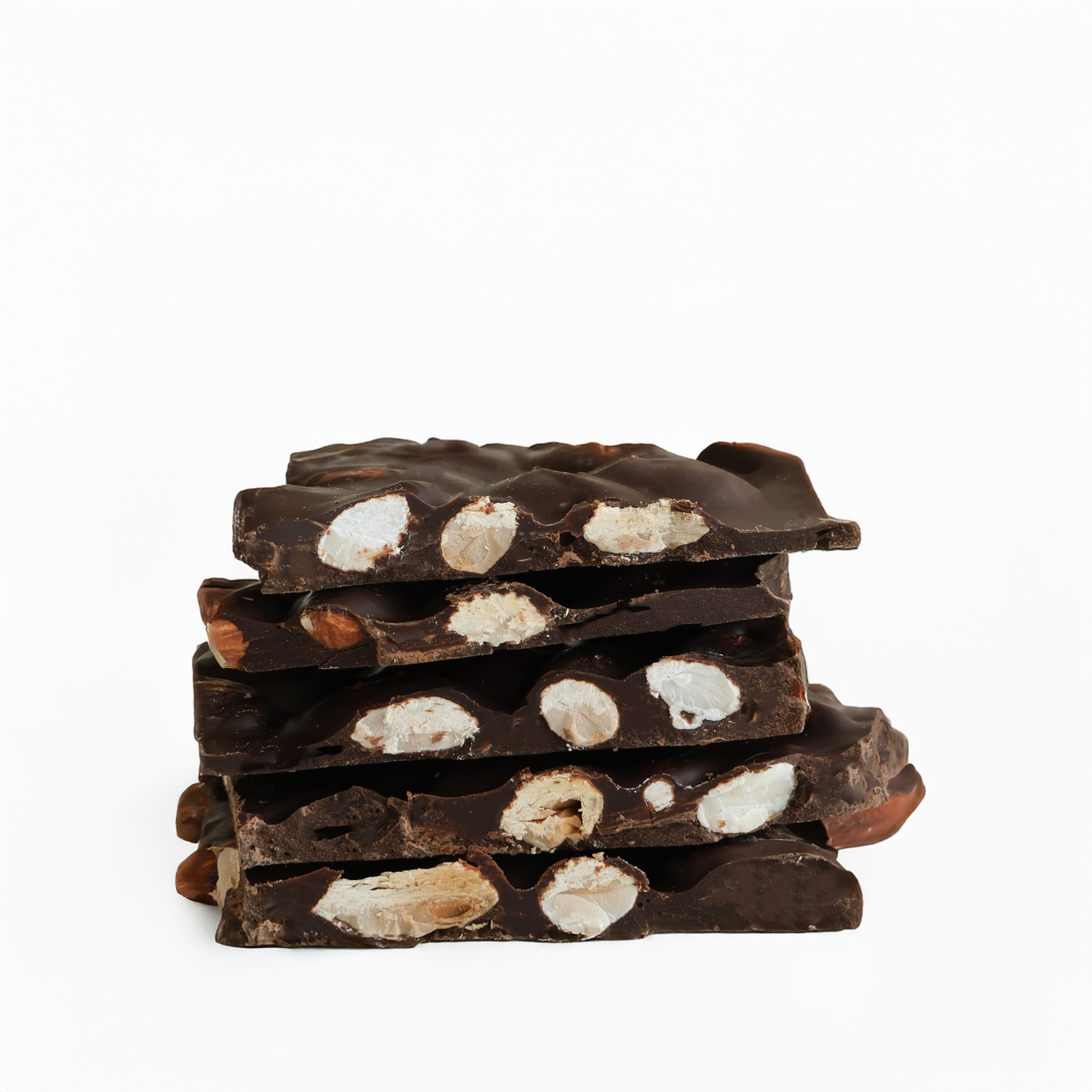Stack of dark chocolate bark with white and brown pieces on a white background