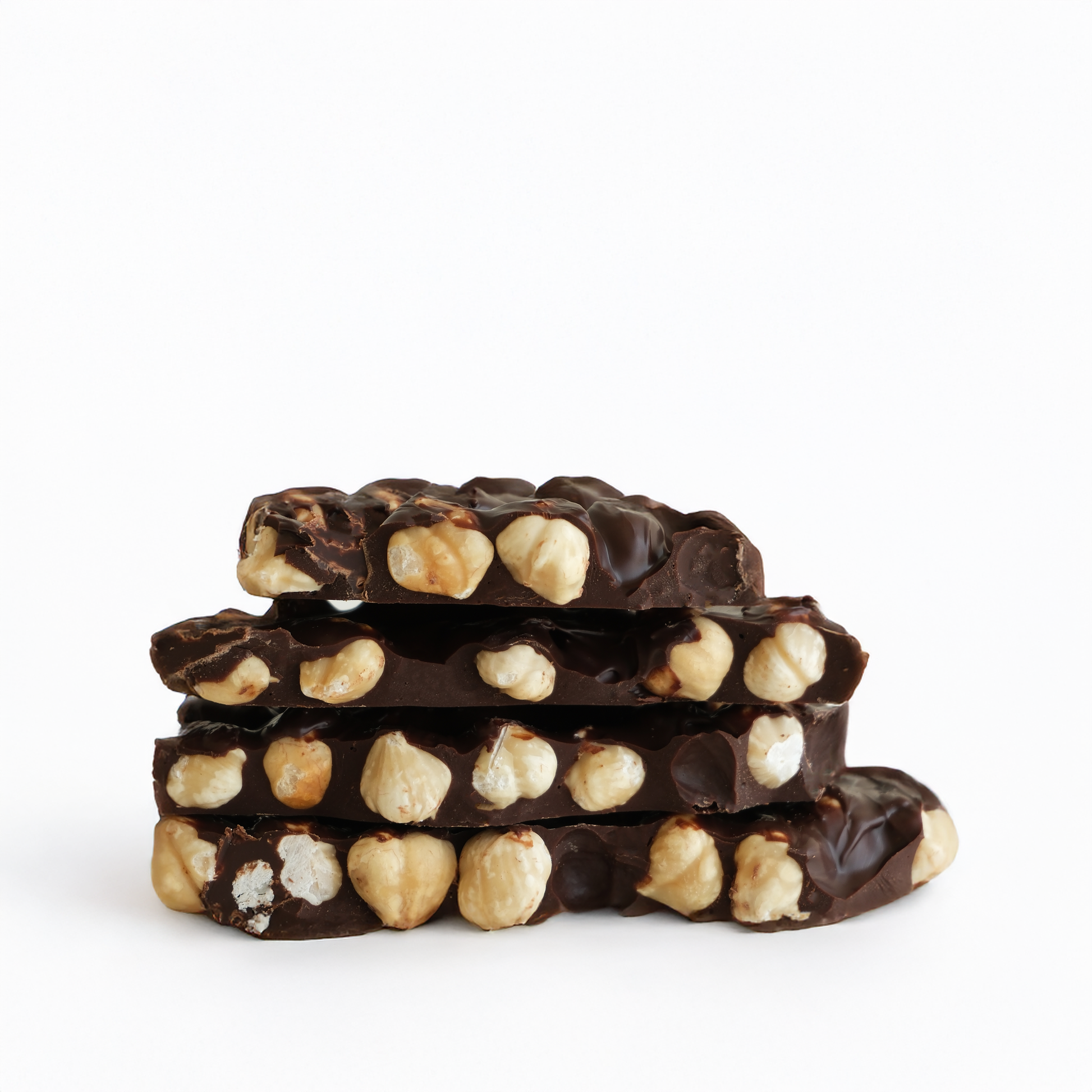 Stack of chocolate bars with nuts on a white background