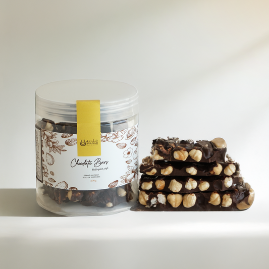 Jar of chocolate bars with a stack of chocolate bars on a white background