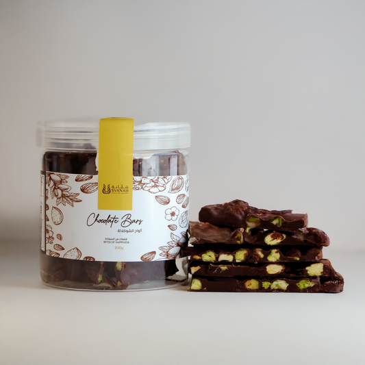 Jar of chocolate bars with a stack of chocolate bars on a white background
