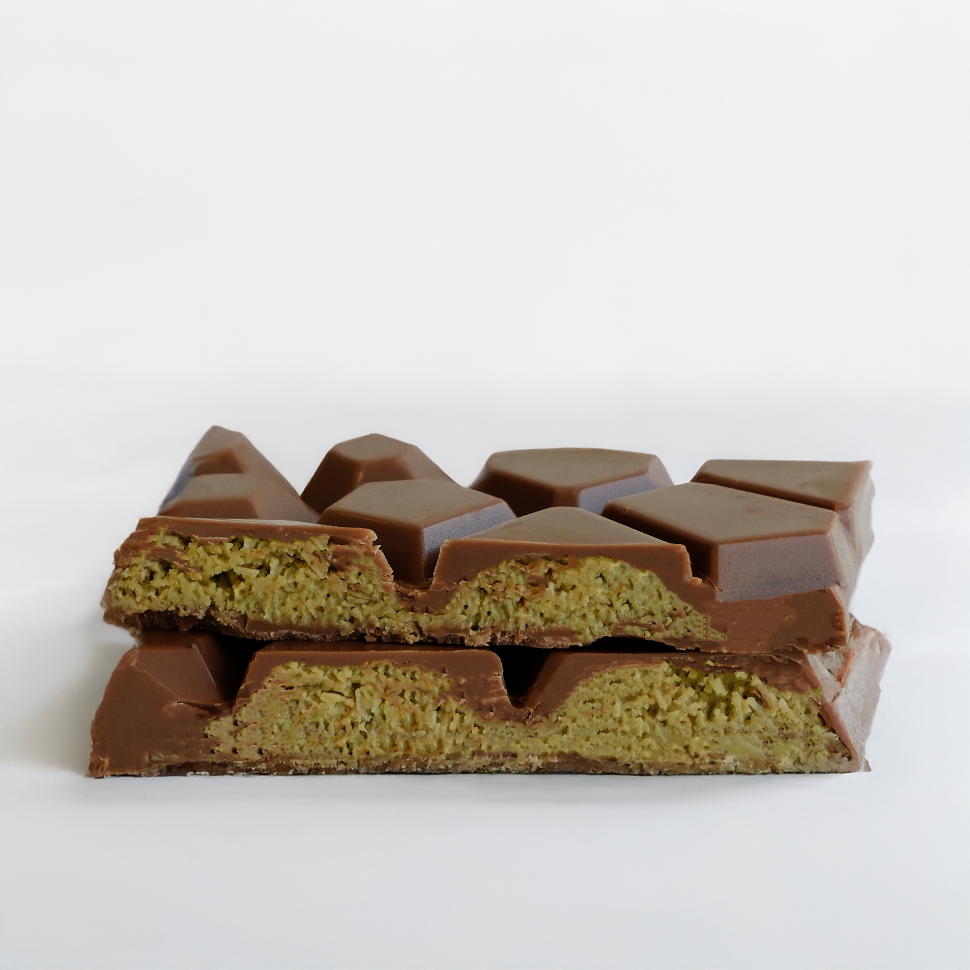 Cross-section of a chocolate bar with visible layers on a white background