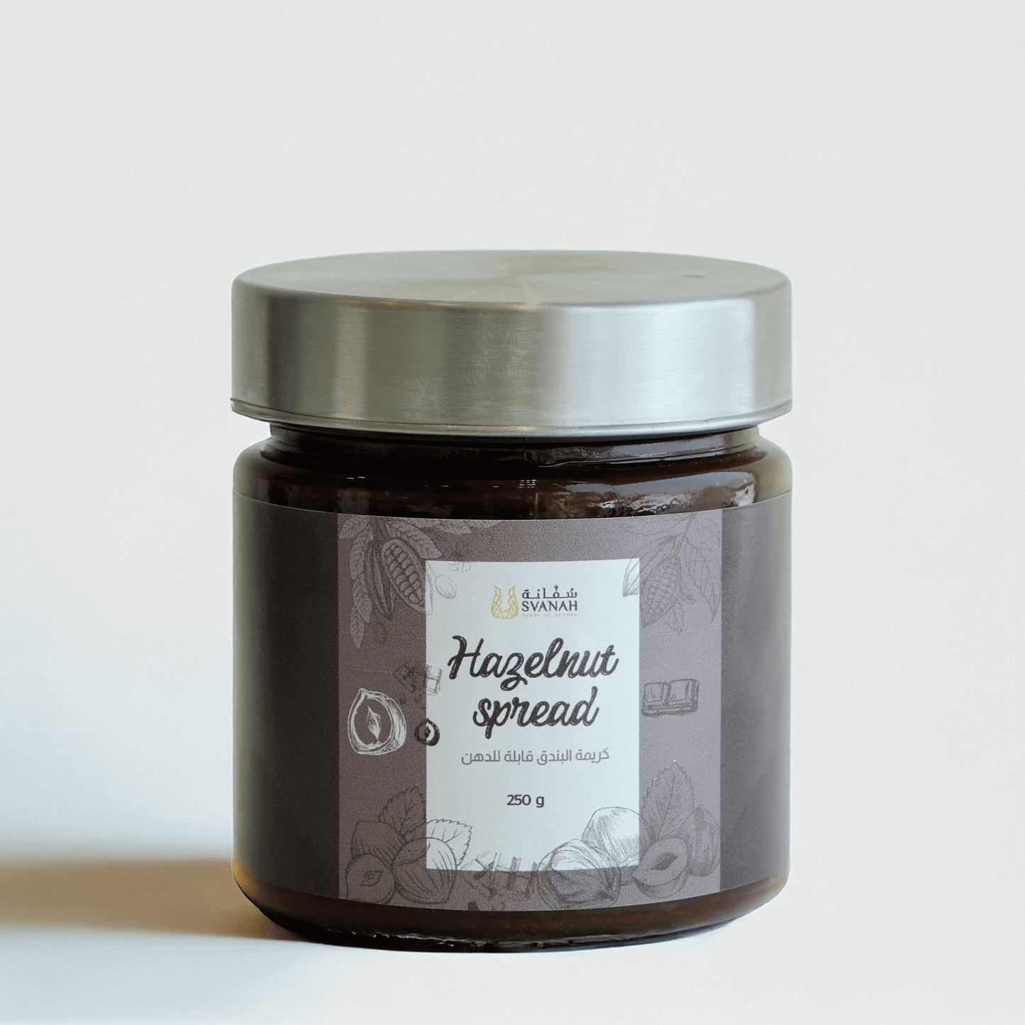 Jar of hazelnut spread with a silver lid on a light background