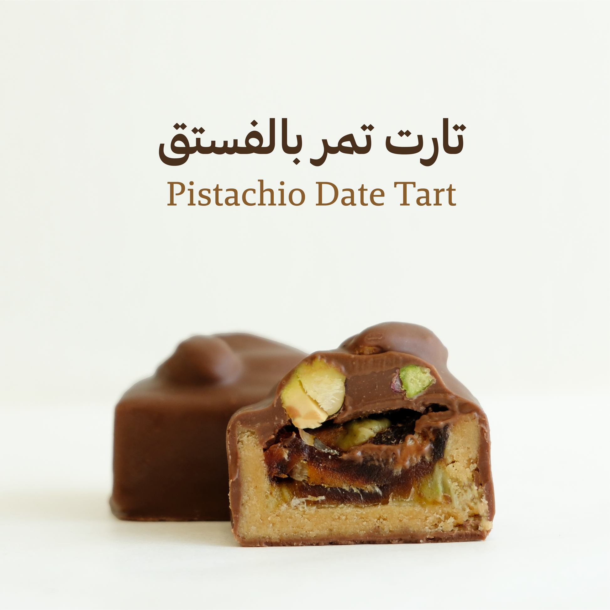 Pistachio Date Tart with chocolate shell on a white background